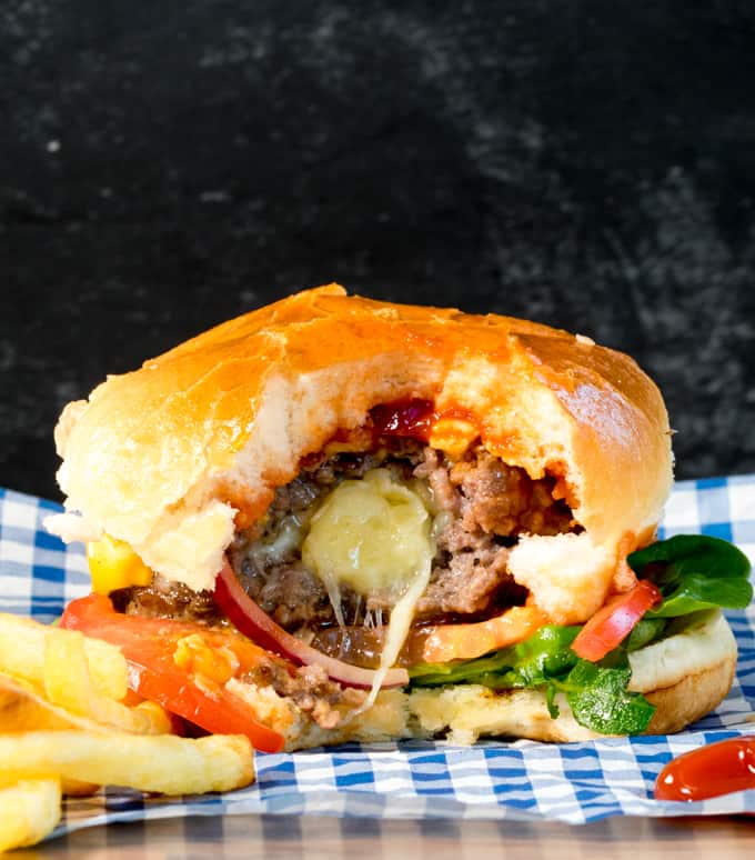This melty cheese stuffed burger with crunchy lettuce, onion and juicy tomatoes, all sandwiched in a golden toasted brioche bun is way better than any takeout burger!