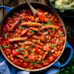 Sausage and bean casserole in a blue pan