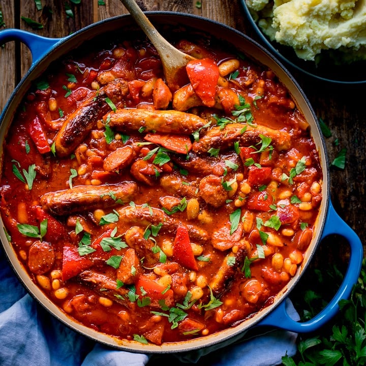 Sausage and bean casserole in a blue pan
