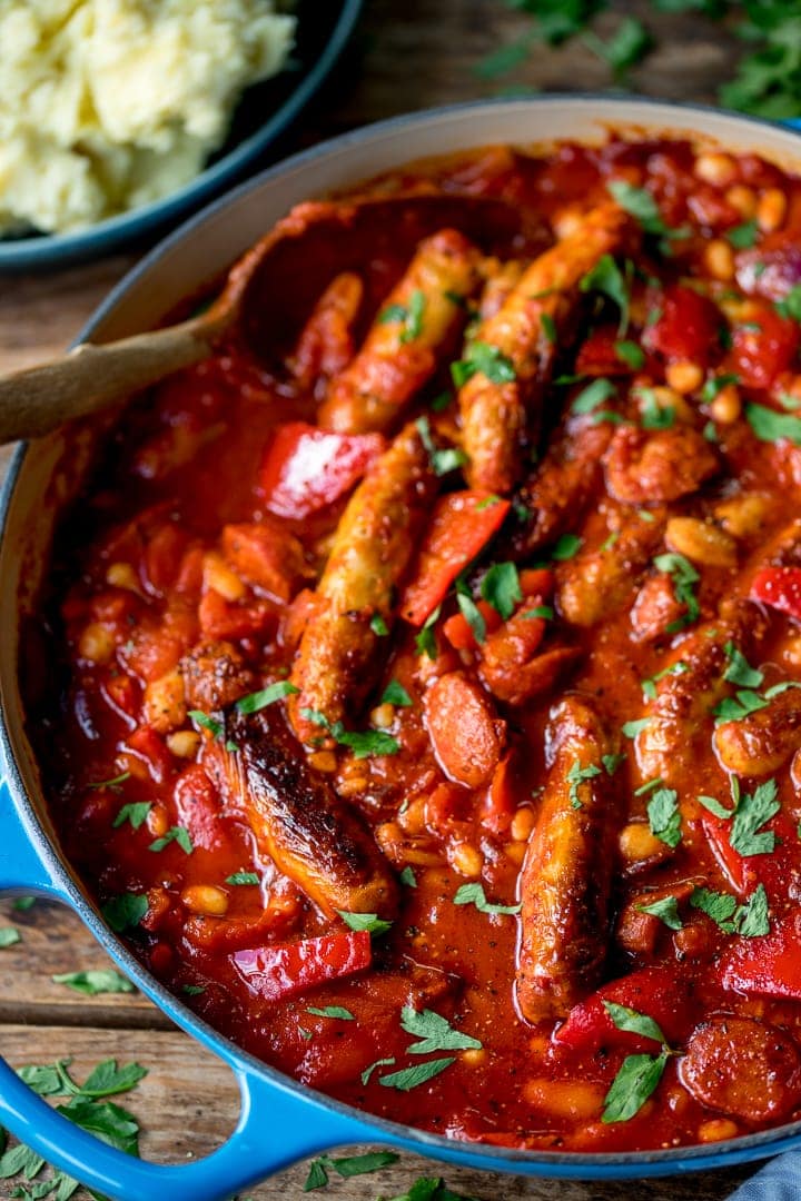 Close up of sausage and bean casserole in a blue pan