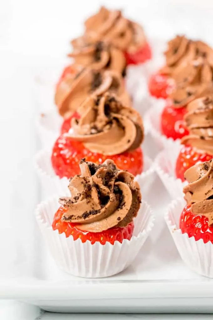 Row of chocolate cheesecake stuffed strawberries