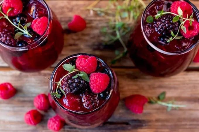 New Year's Eve Rum Berry Cocktail! With rum, Cointreau, pomegranate juice and ginger beer! Use frozen berries instead of ice cubes to finish the look!