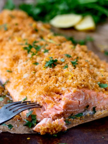 This Garlic Bread Crusted Salmon makes an easy and tasty centerpiece for your family table! The crispy coating ensures the salmon is beautifully moist!