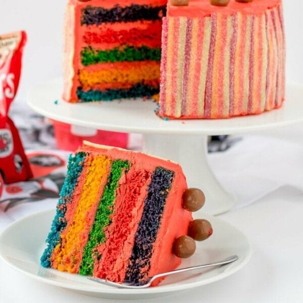 Colourful Layers, Vimto Buttercream And Fizzy Rainbow Belt Coating - Finished Off With Little Malteser Faces! All the right ingredients for a wacky Red Nose Day Rainbow Cake!