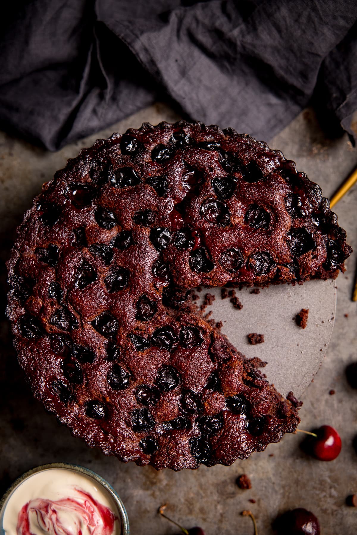 Overhead of Chocolate Cherry Cake with a slice taken out.