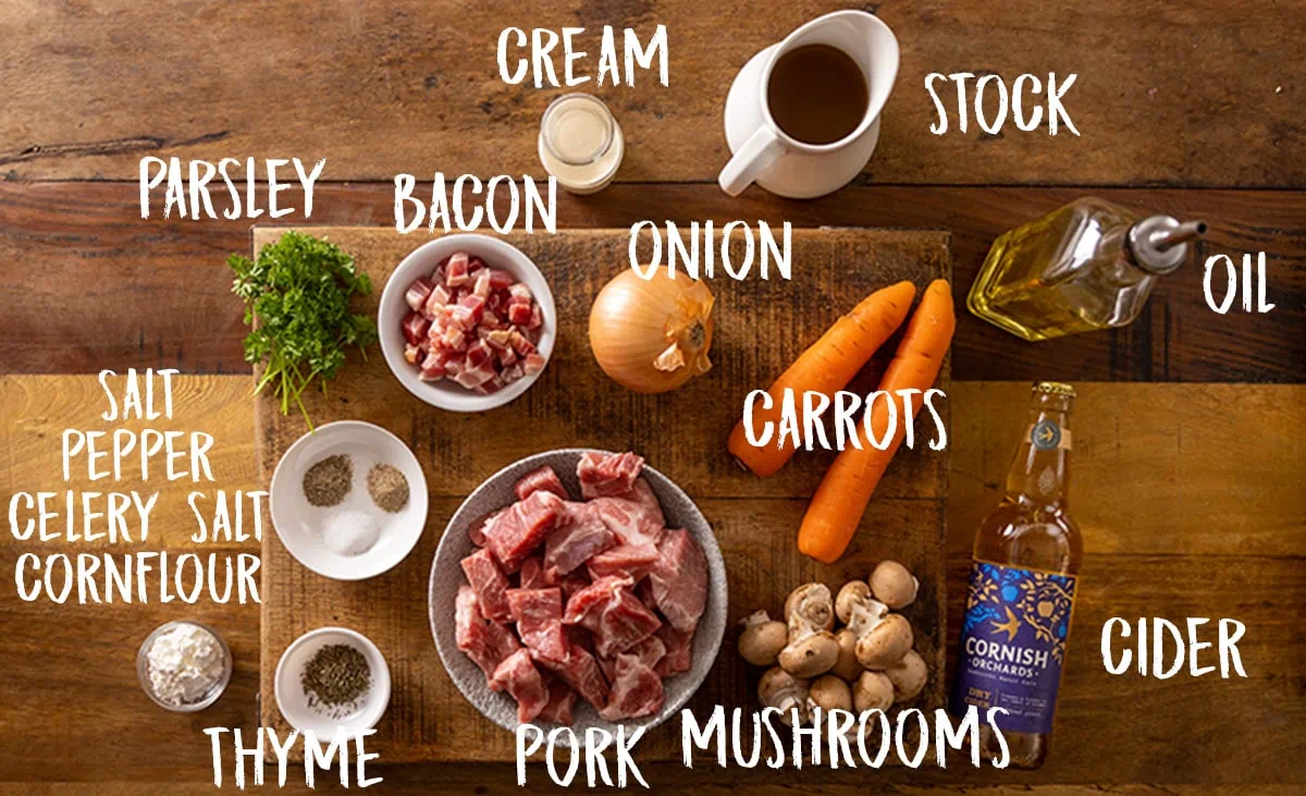 Ingredients for slow cooked pork casserole on a wooden table