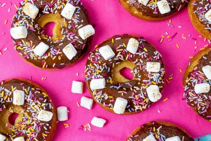 Chocolate Baked S'mores Doughnuts - quick and easy doughnuts with chocolate ganache, marshmallows and lots of sprinkles! Great for a bakesale!