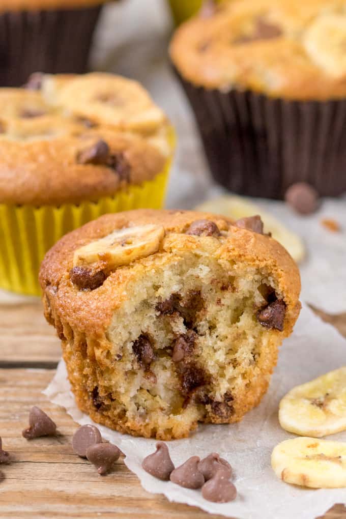 Close up picture of Light and fluffy Bakery Style Chocolate Chip Banana Muffins with a bite taken out