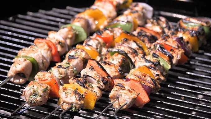 Chicken kebabs cooking on the barbecue