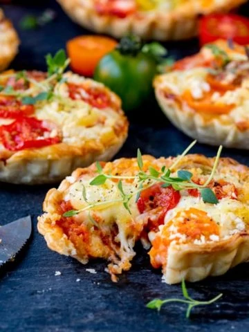 Cheese and Tomato Tarts with a rich tomato ragu and creamy béchamel sauce encased in shortcrust pastry. The best vegetarian lunch!