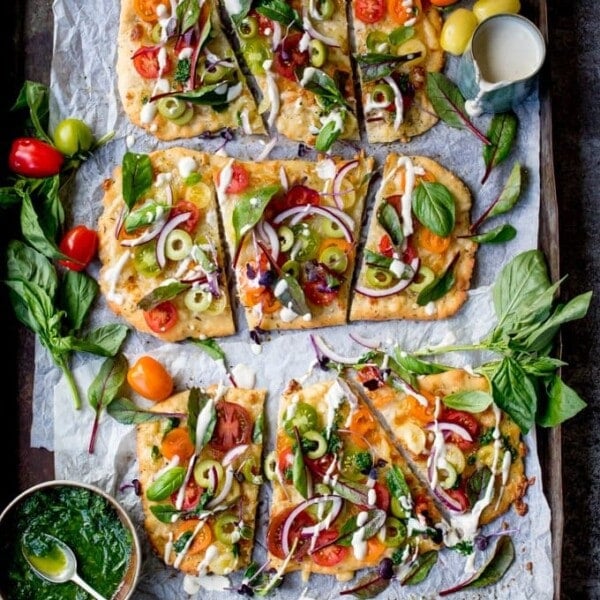 This Vegetarian Summer Tomato Pizza with Basil Garlic Butter and creamy cashew drizzle is a meal even the meat-eaters will love. The homemade no-knead, no-prove flatbread base is super quick to make!