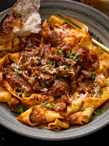Beef ragu with pappardelle in a green bowl