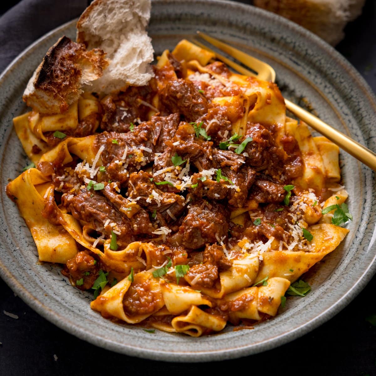 Beef ragu with pappardelle in a green bowl