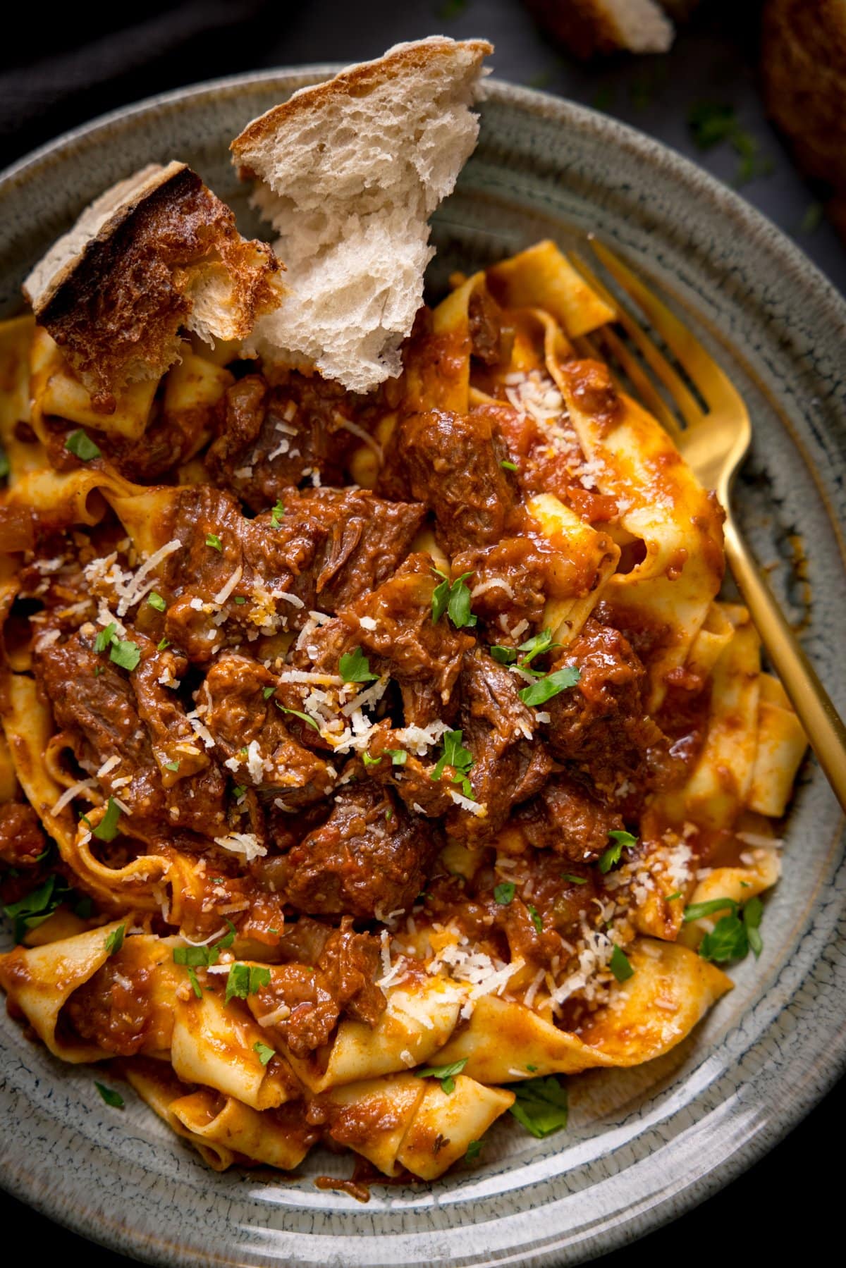 Overhead image of beef ragu and pasta in a bowl.