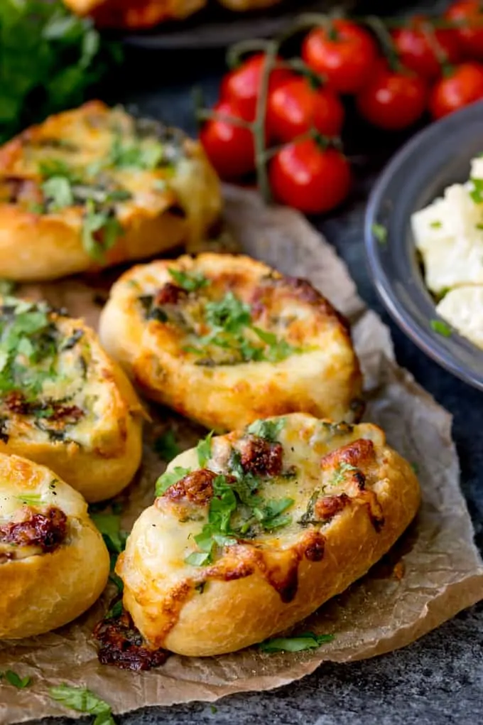 Cheese Stuffed Bread with Spinach and Sun Dried Tomato with vine tomatoes in the background