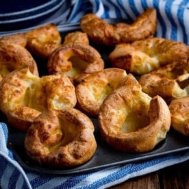 Yorkshire puddings in a tin on a wooden table