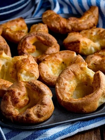 Yorkshire puddings in a tin on a wooden table