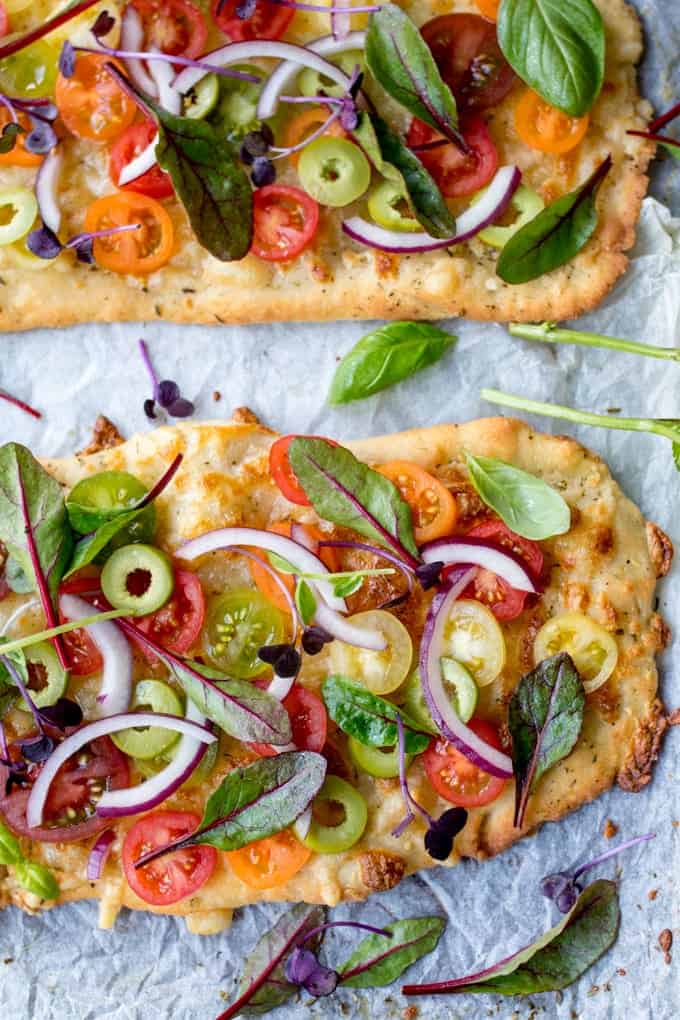 This Vegetarian Summer Tomato Pizza with Basil Garlic Butter and creamy cashew drizzle is a meal even the meat-eaters will love. The homemade no-knead, no-prove flatbread base is super quick to make!