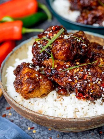 This Chinese Crispy Chicken with Honey Garlic Sauce is one of those meals everyone loves! Easy to make spicy or mild. Way tastier than takeout!