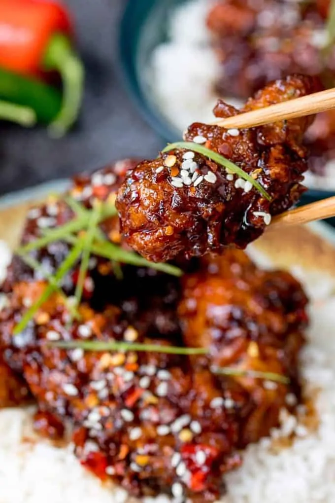 Closeup of a piece of Chinese fried Chicken in a Honey Garlic Chilli Sauce 