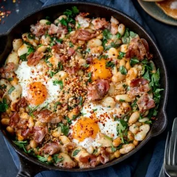 No, it's not shakshuka. Not a tomato in sight! This is my Spicy Egg Breakfast with Smashed Beans and Pancetta! A different way to serve your morning eggs! #onepan #brunch #bruncheggs #smashedbeans
