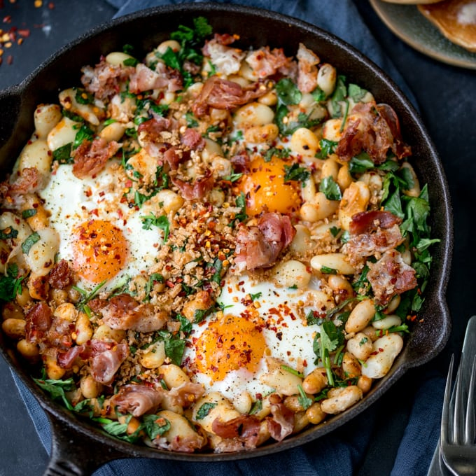 No, it's not shakshuka. Not a tomato in sight! This is my Spicy Egg Breakfast with Smashed Beans and Pancetta! A different way to serve your morning eggs! #onepan #brunch #bruncheggs #smashedbeans