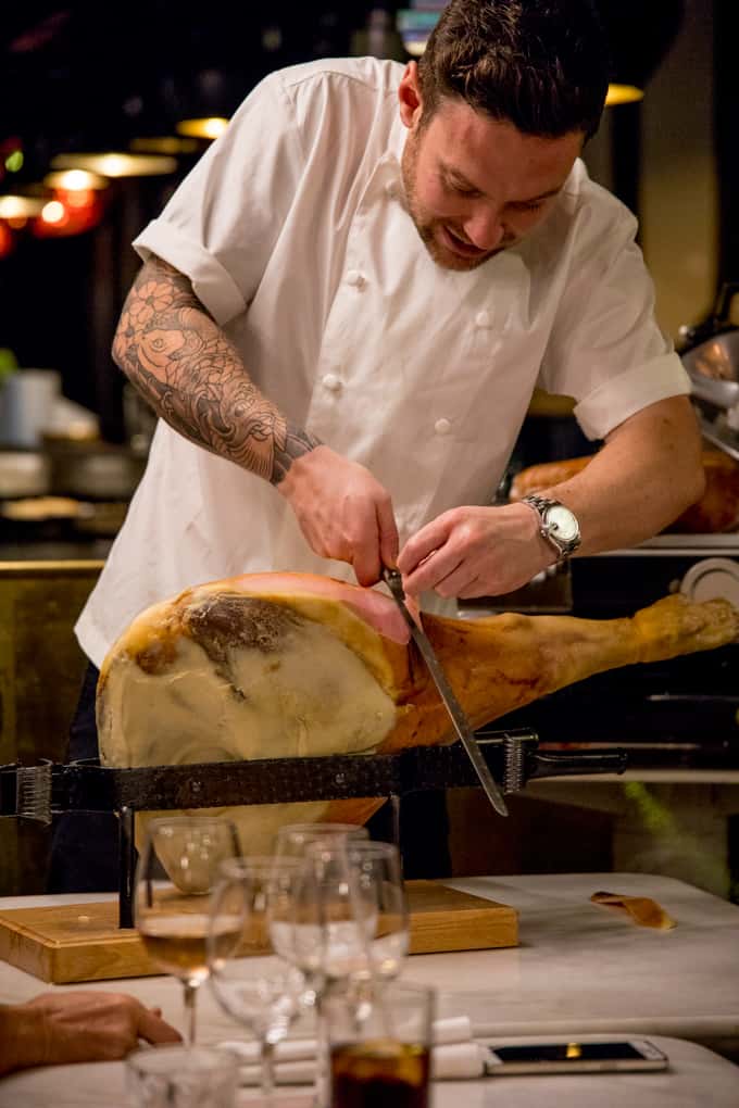 Chef slicing Proscuitto di San Daniele at an event