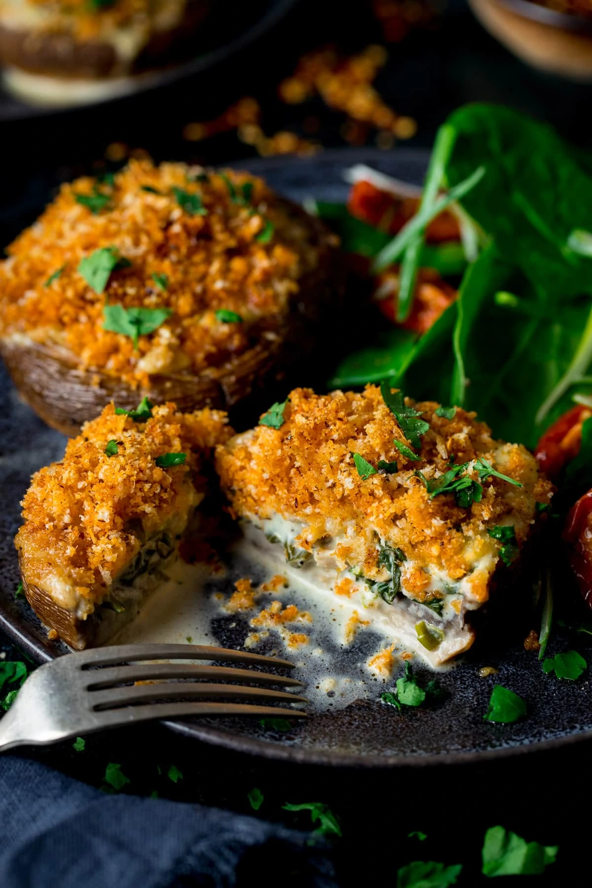 Stuffed mushrooms topped with crispy crumb topping sliced in half