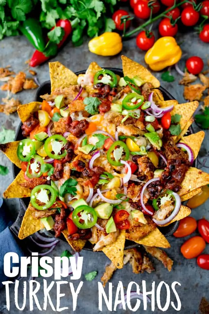 What should you do with all that leftover turkey....Make these Crispy Turkey Nachos!! Crispy fajita-spiced turkey, beans, and a ton of melted cheese!!! #leftoverturkey #turkeynachos #mexicanfood
