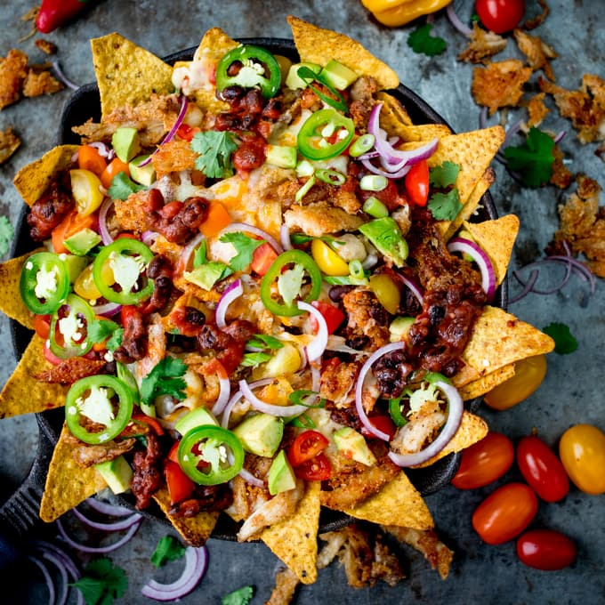 What should you do with all that leftover turkey....Make these Crispy Turkey Nachos!! Crispy fajita-spiced turkey, beans, and a ton of melted cheese!!!