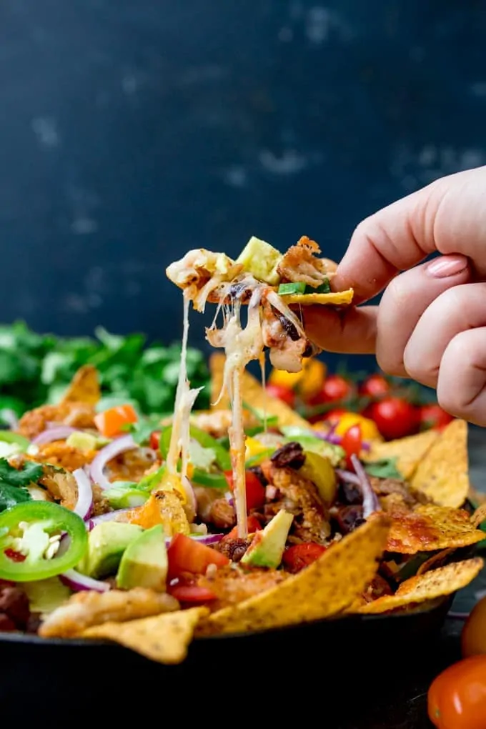 What should you do with all that leftover turkey....Make these Crispy Turkey Nachos!! Crispy fajita-spiced turkey, beans, and a ton of melted cheese!!!