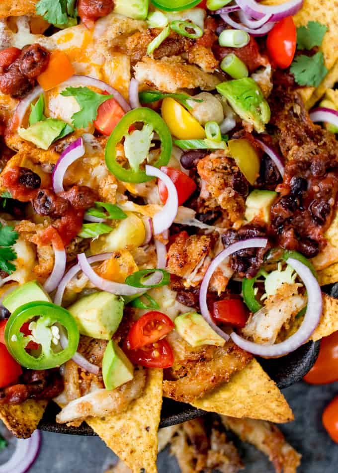 What should you do with all that leftover turkey....Make these Crispy Turkey Nachos!! Crispy fajita-spiced turkey, beans, and a ton of melted cheese!!!