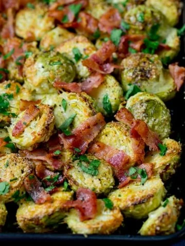 Square image showing rray of roasted sprouts with bacon bits