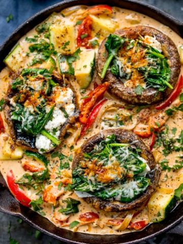 Tuscan Style Stuffed Mushrooms in Creamy Sun Dried Tomato Sauce makes a great veggie dish, packed with flavour! Gluten free too! #glutenfreevegetarianfood #glutenfreedinner #tuscanmushrooms #mushrooms KitchenSanctuary.com