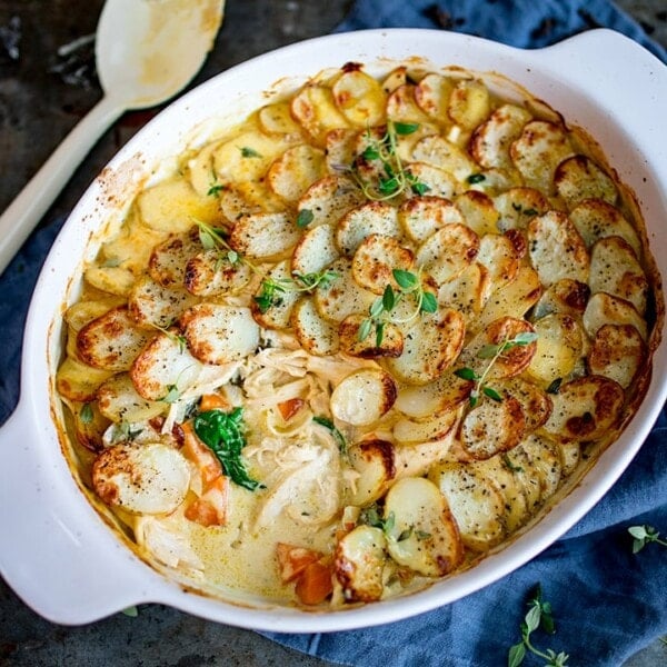 This Creamy Chicken and Potato Bake with extra veggies is a whole meal in one dish! Kind of like a creamy chicken, carrot and spinach casserole, topped with potato gratin!