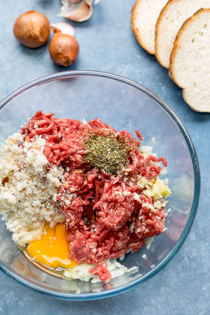 Mixture for meatballs in a bowl on a blue background