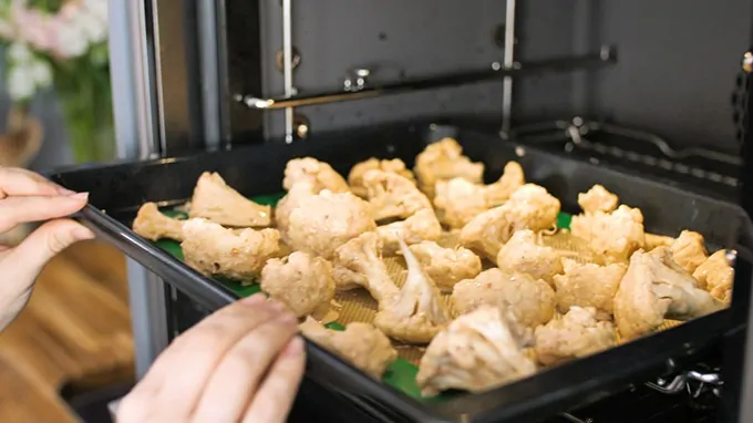 Cauliflower florets going into the oven