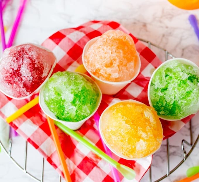 5 fruit flavoured snow cones on a chequered napkin