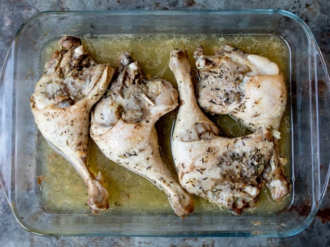 4 roasted duck legs in a baking dish