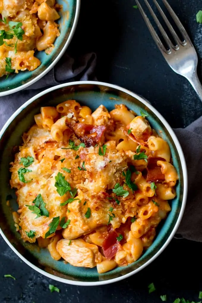 Bowl of chicken and bacon mac and cheese on a dark background
