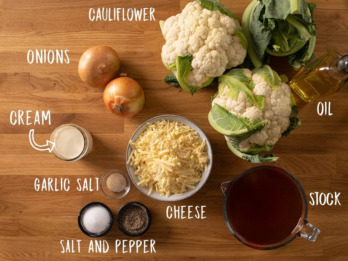 Ingredients for cauliflower soup on a wooden table