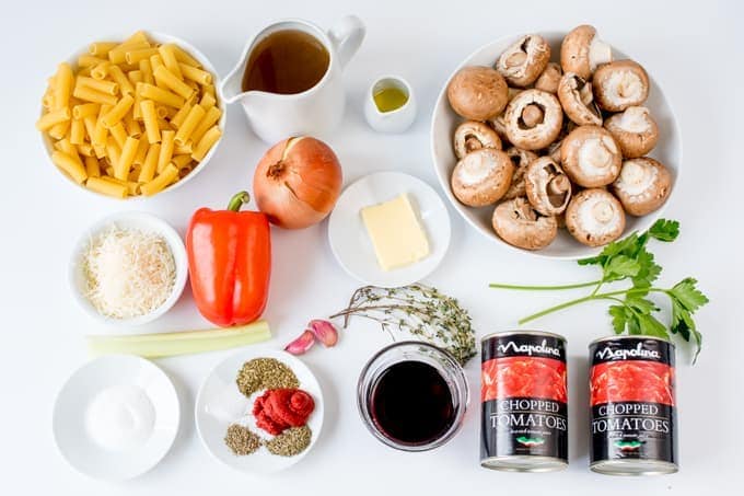 Ingredients for mushroom ragu with pasta on a white background