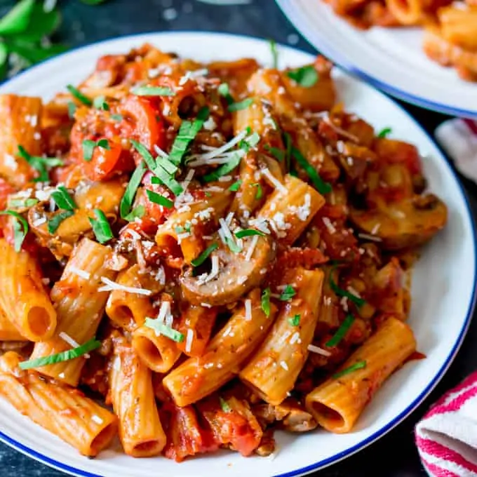 Square image of a plate of mushroom ragu with rigatoni