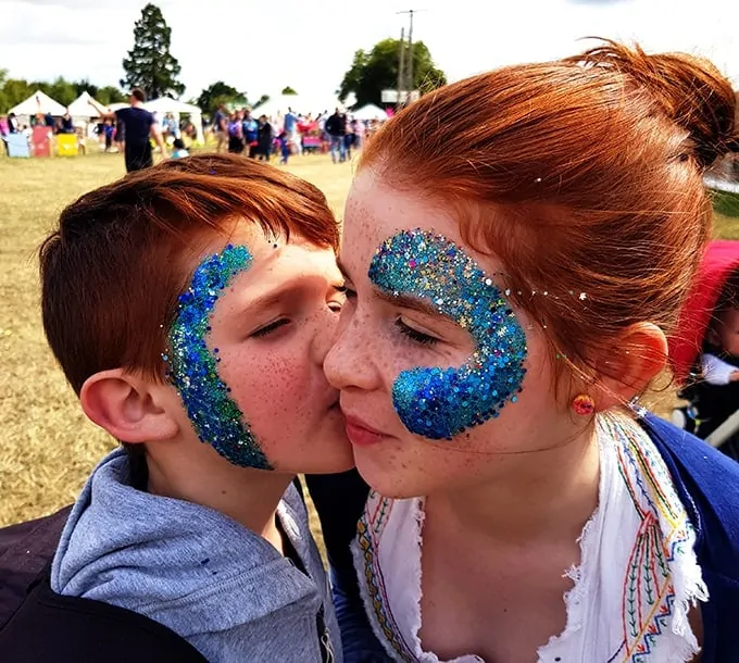The kids with blue sparkle glitter on their faces at the Big Feastival