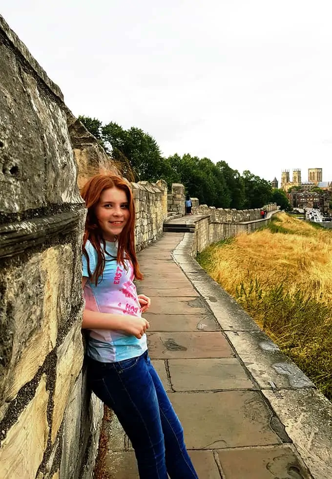 My daughter standing on the city walls in York