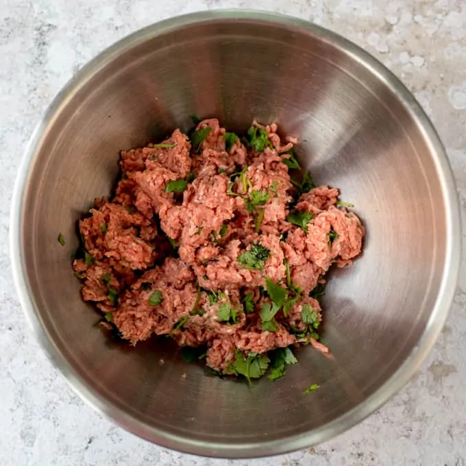 Beef mince and coriander in a bowl