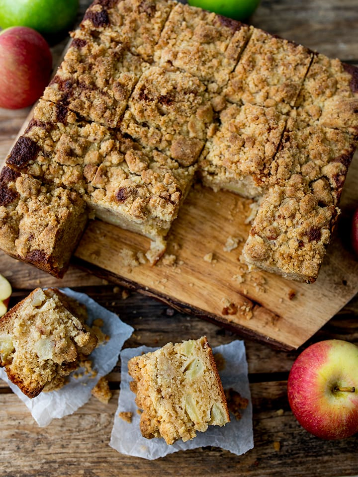 apple crumble cake on a chopping board, sliced into squares