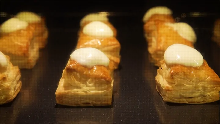 Mozzarella melting on puff pastry squares