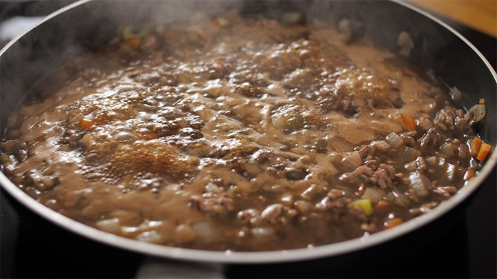 Minced beef and gravy bubbling in a pan