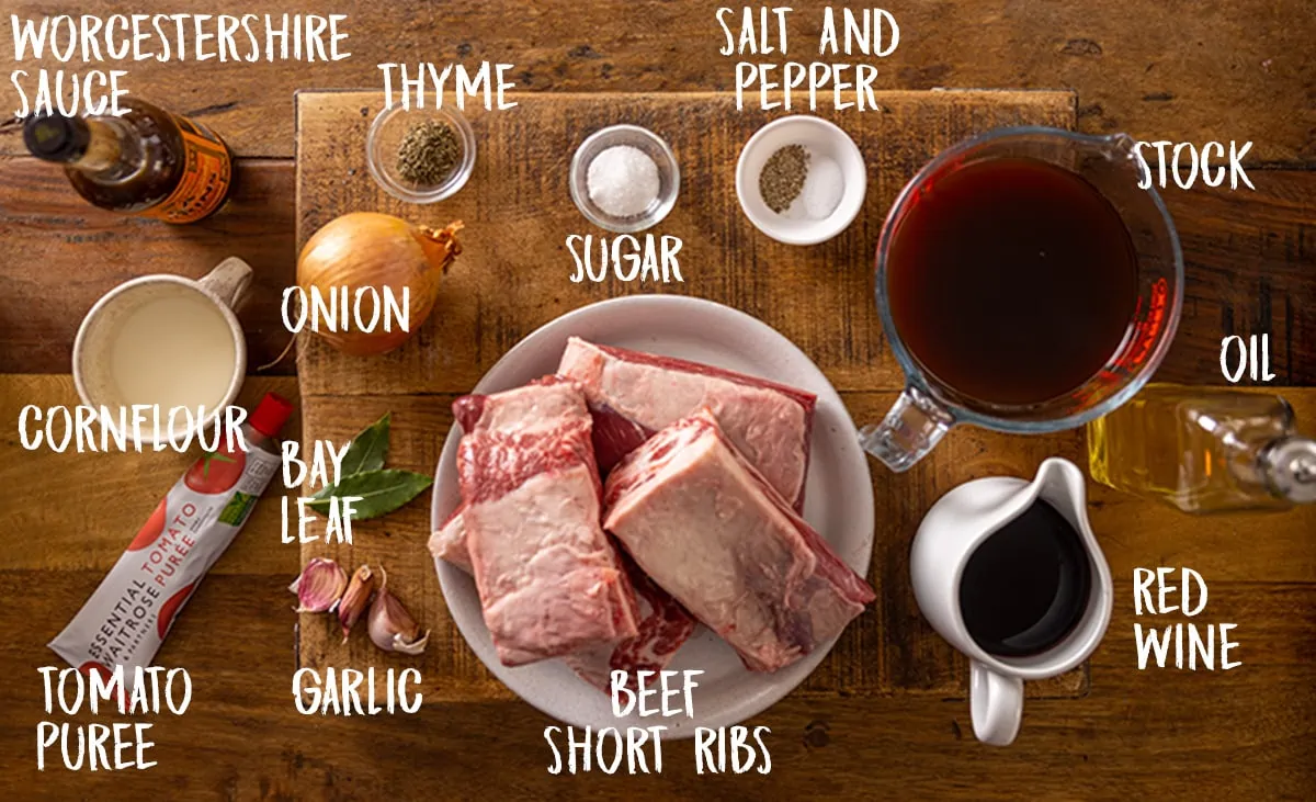 Ingredients for slow cooker short ribs recipe on a wooden table